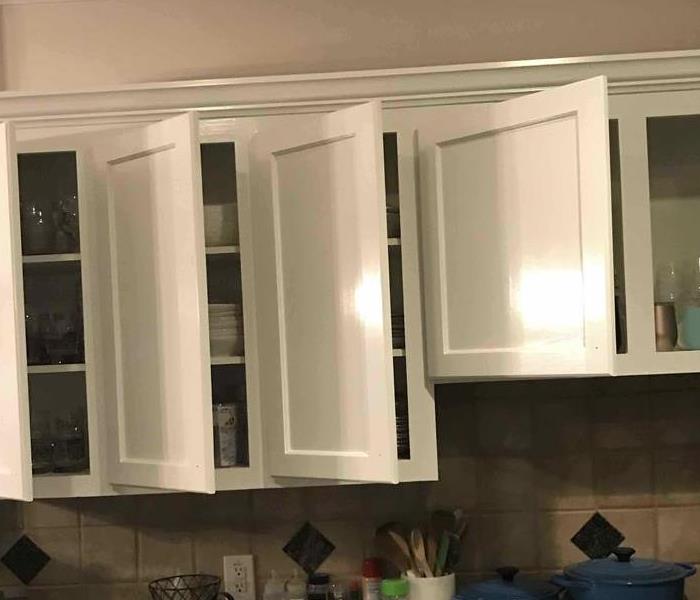 Kitchen cabinets with restored and repainted doors.