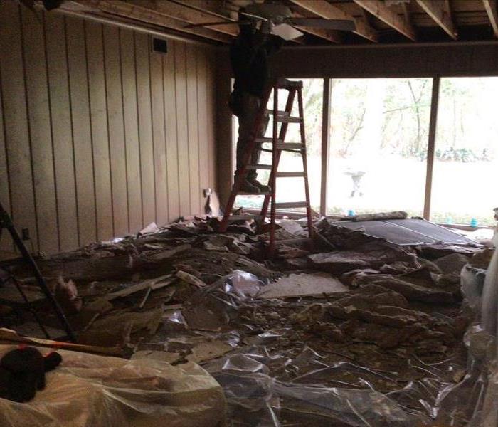 Ceiling torn down in home affected by storm damage.