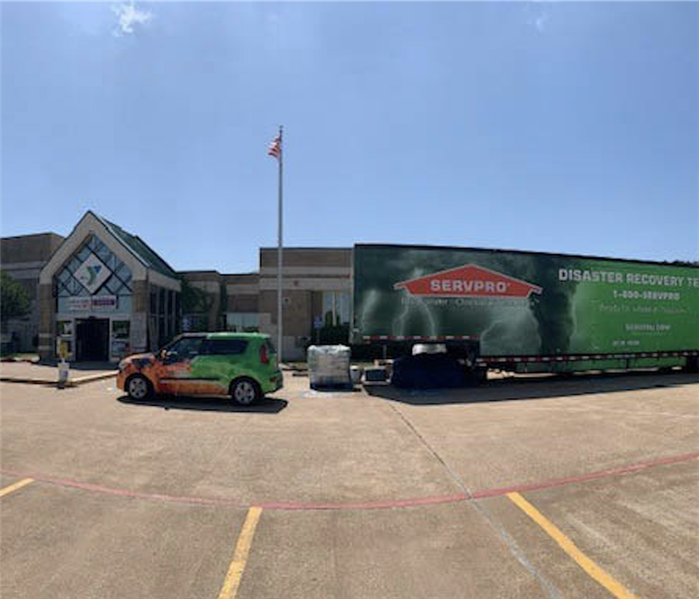SERVPRO trailer and car outside a commercial property.
